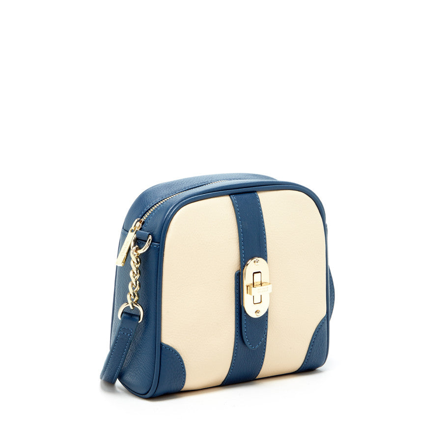 Close-up of SUSU crossbody bag gold twist lock closure and zipper detail