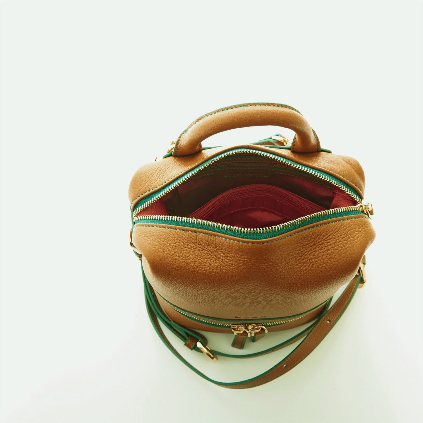 SUSU Ashley brown leather backpack interior showing red lining and cell phone slot