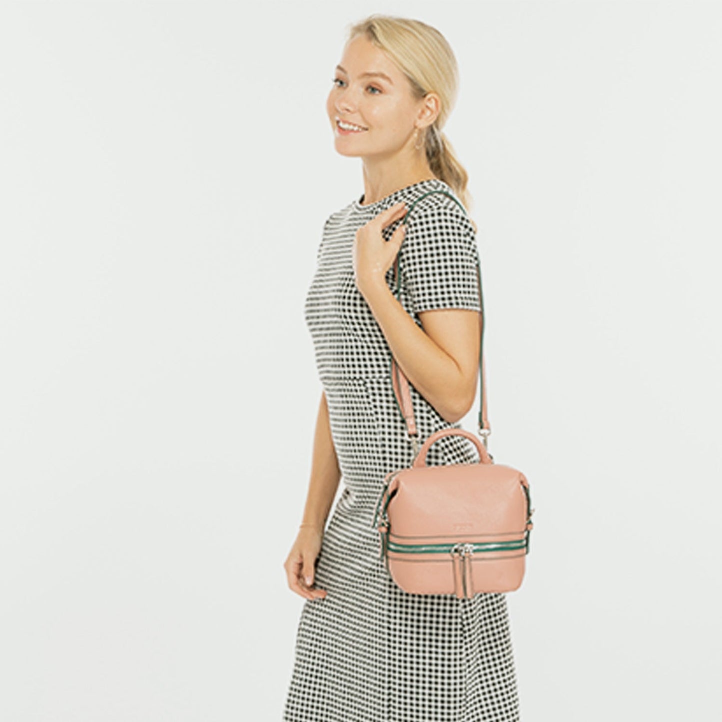 SUSU Ashley backpack worn as convertible crossbody bag with adjustable straps