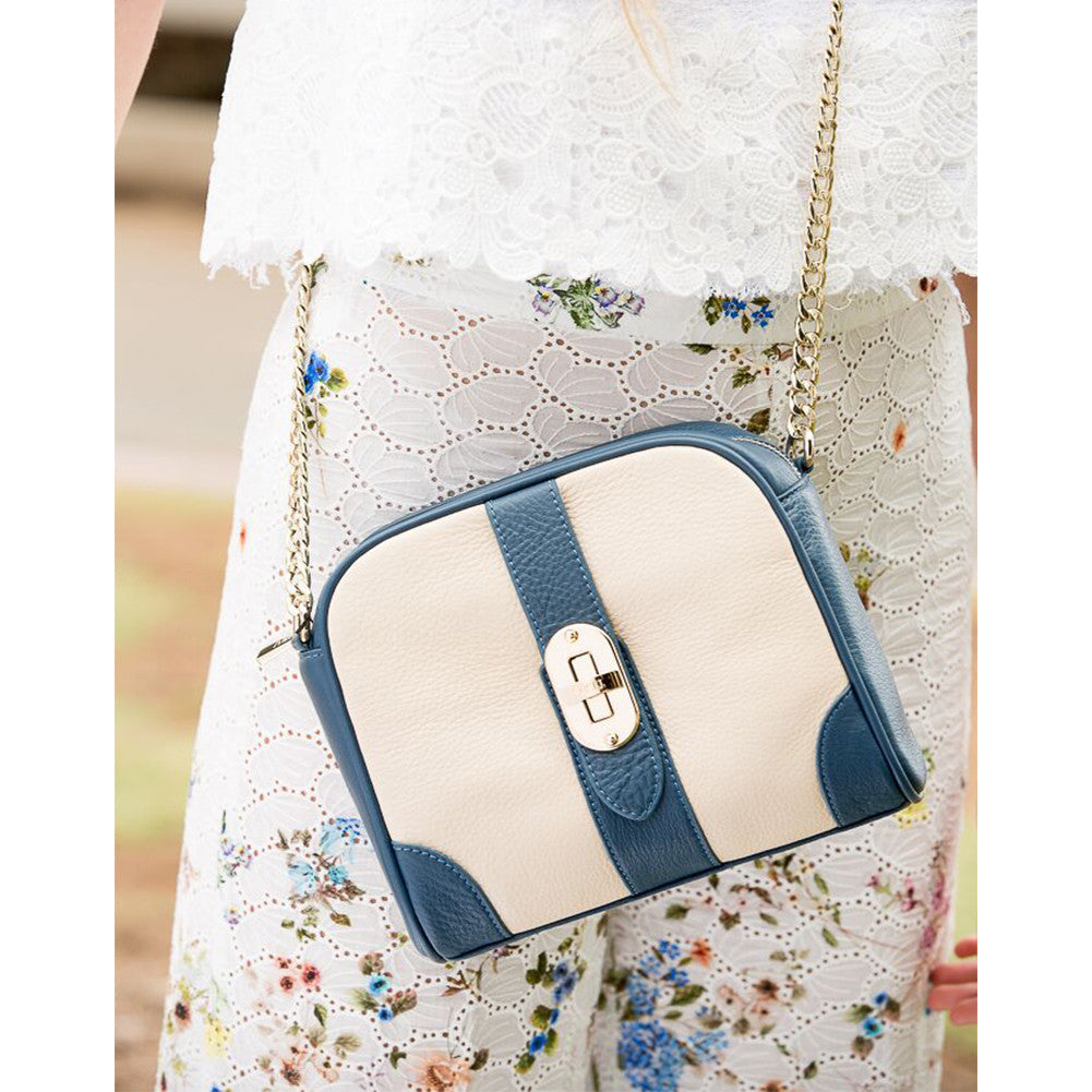 Woman wearing SUSU off white blue crossbody bag as shoulder bag
