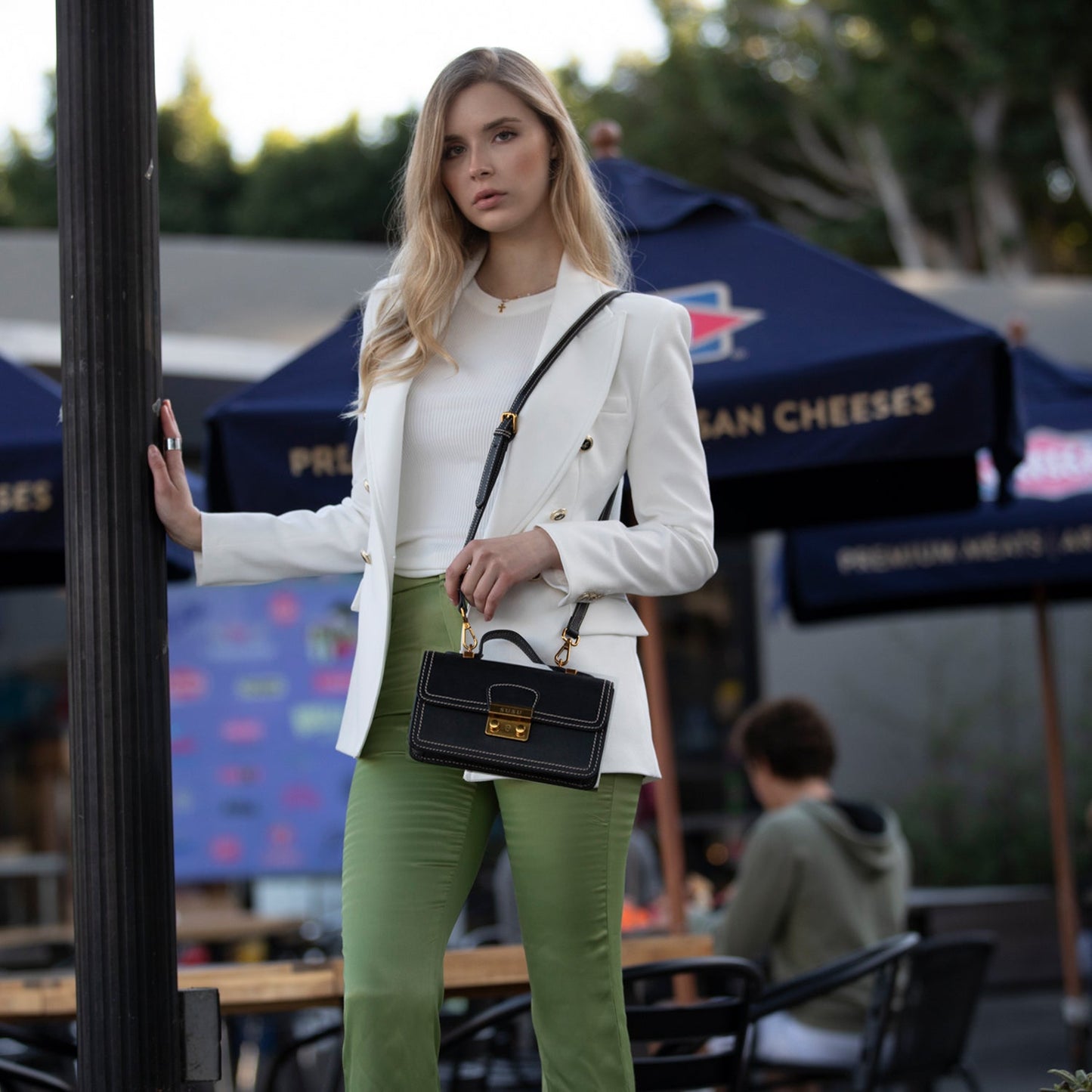 SUSU black crossbody bag worn with adjustable strap for hands-free convenience