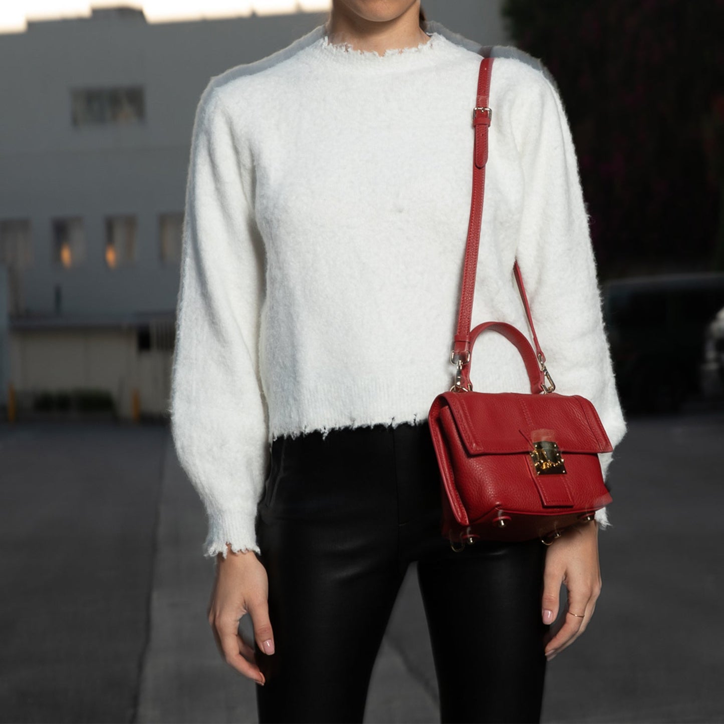 SUSU convertible backpack worn as crossbody bag showing adjustable strap configuration