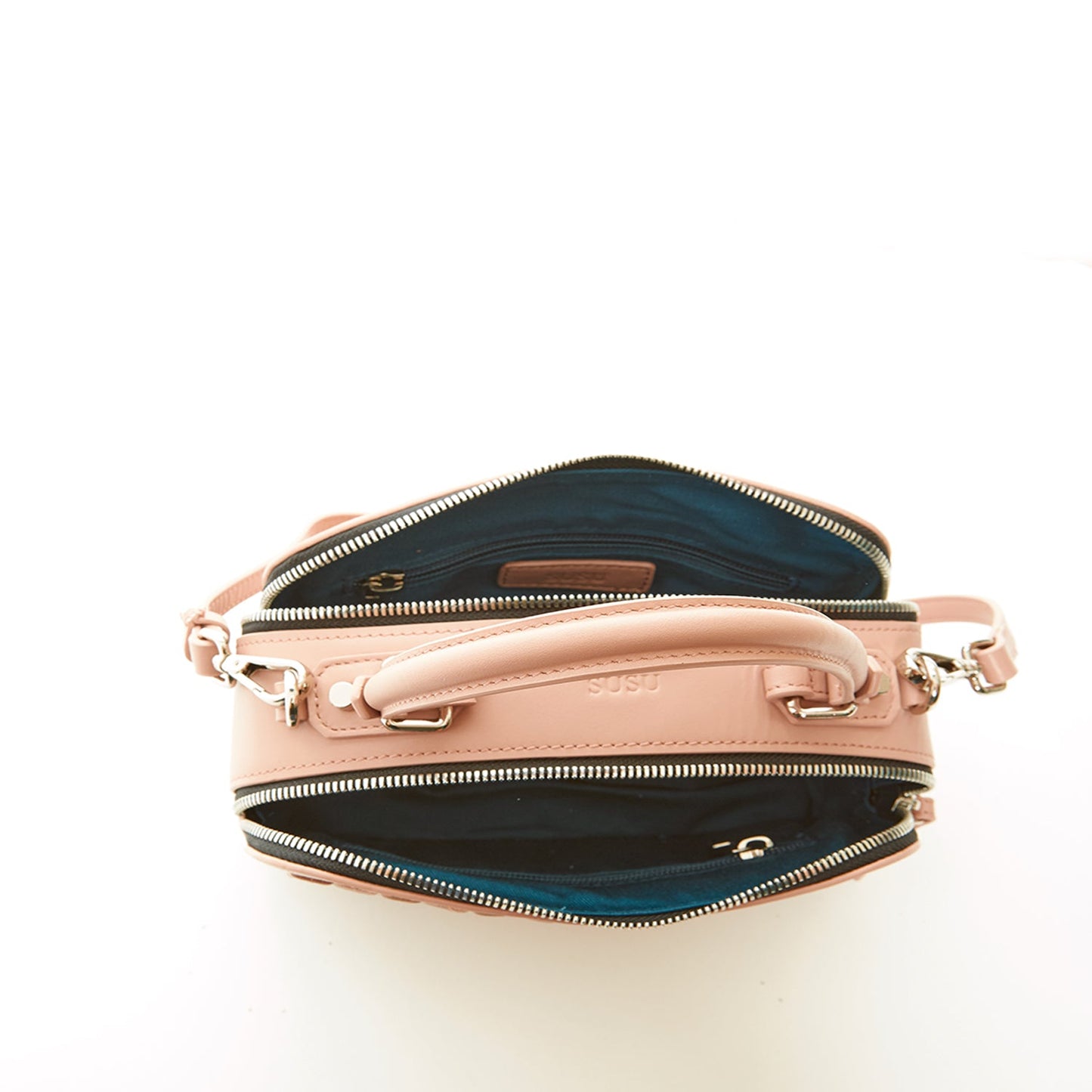 SUSU Kayla pink leather bag interior showing teal lining and zippered compartments