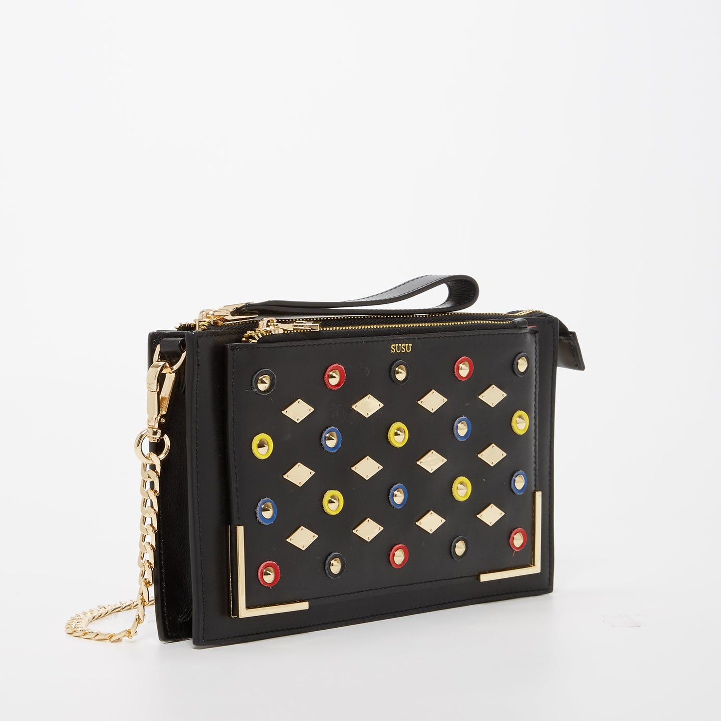 Close-up of SUSU Austin clutch gold-plated leather appliqué details