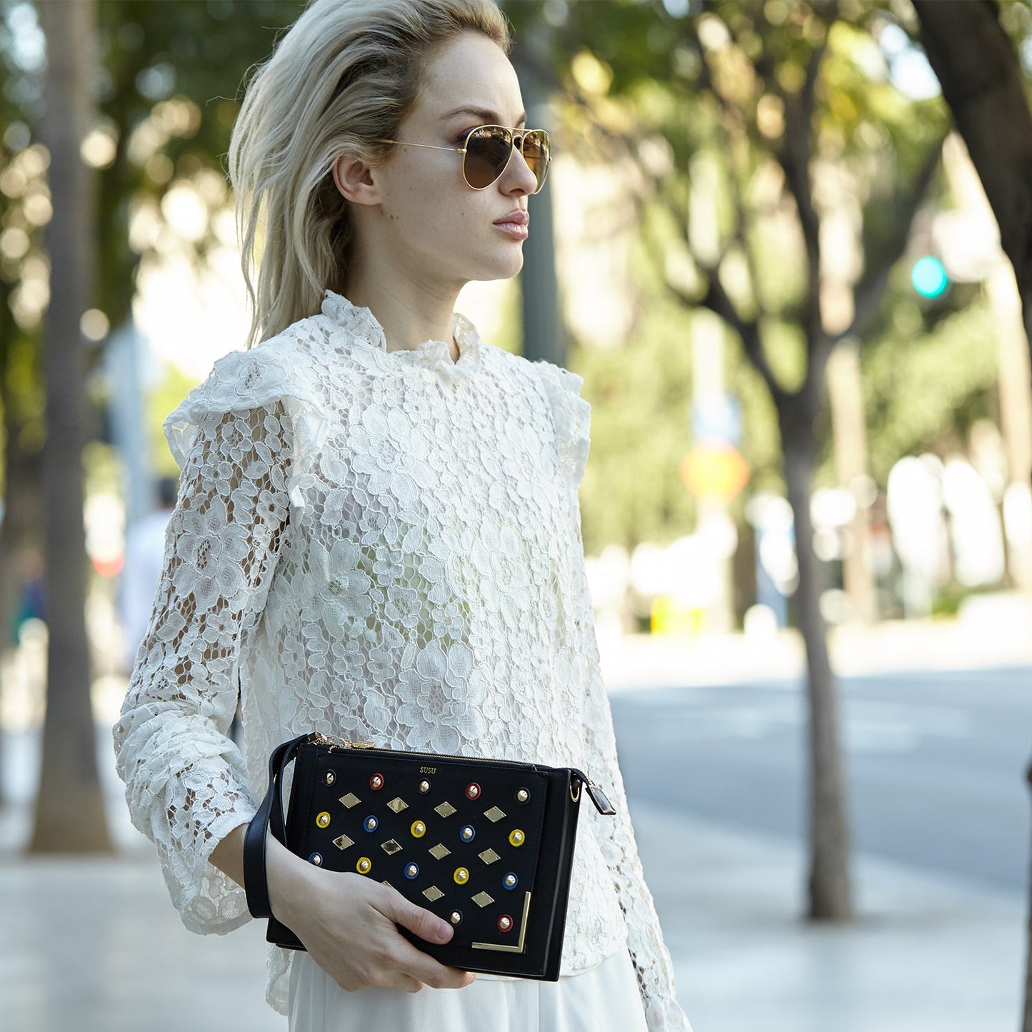 SUSU Austin clutch styled as wrist clutch with leather strap
