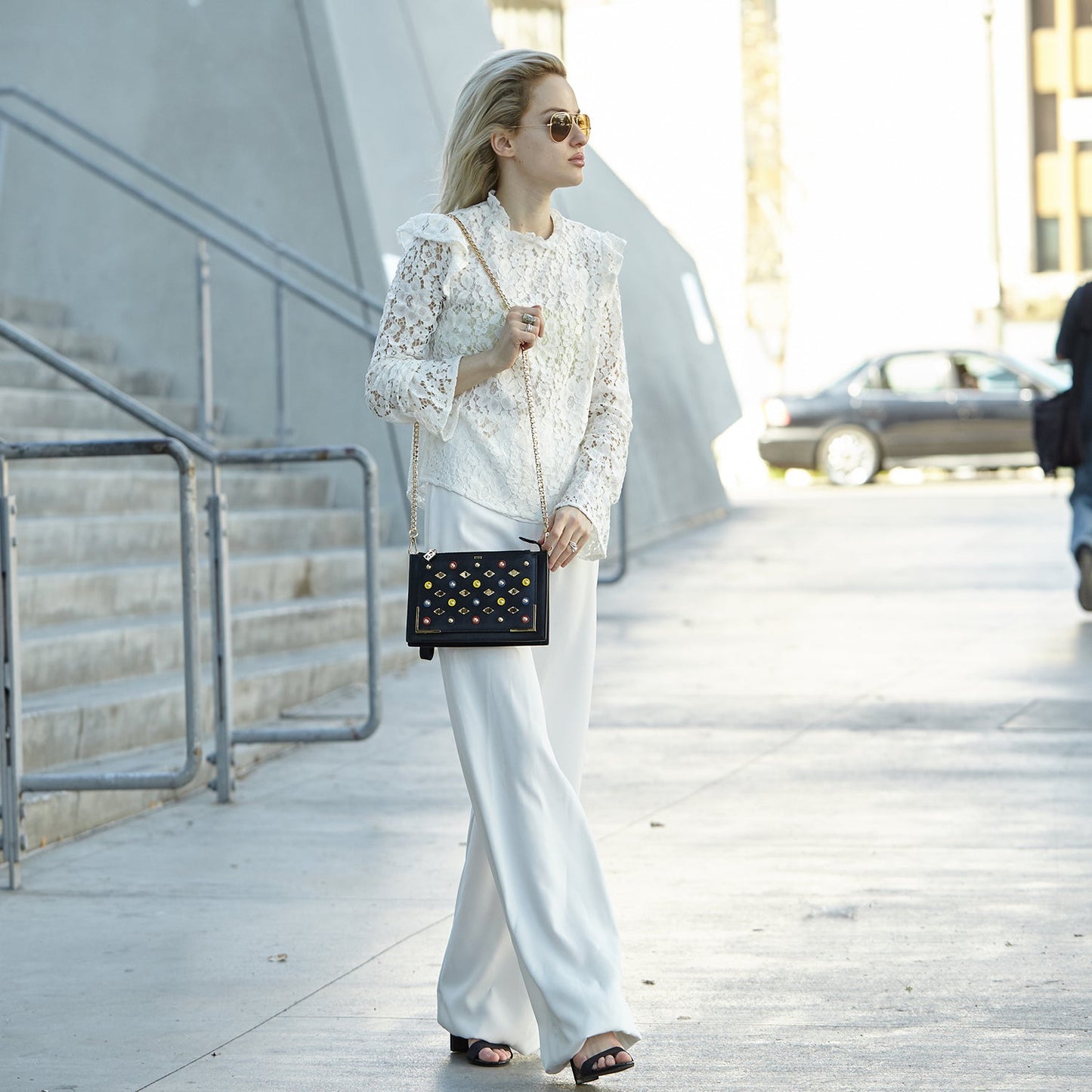 SUSU Austin convertible clutch worn as crossbody with gold chain strap