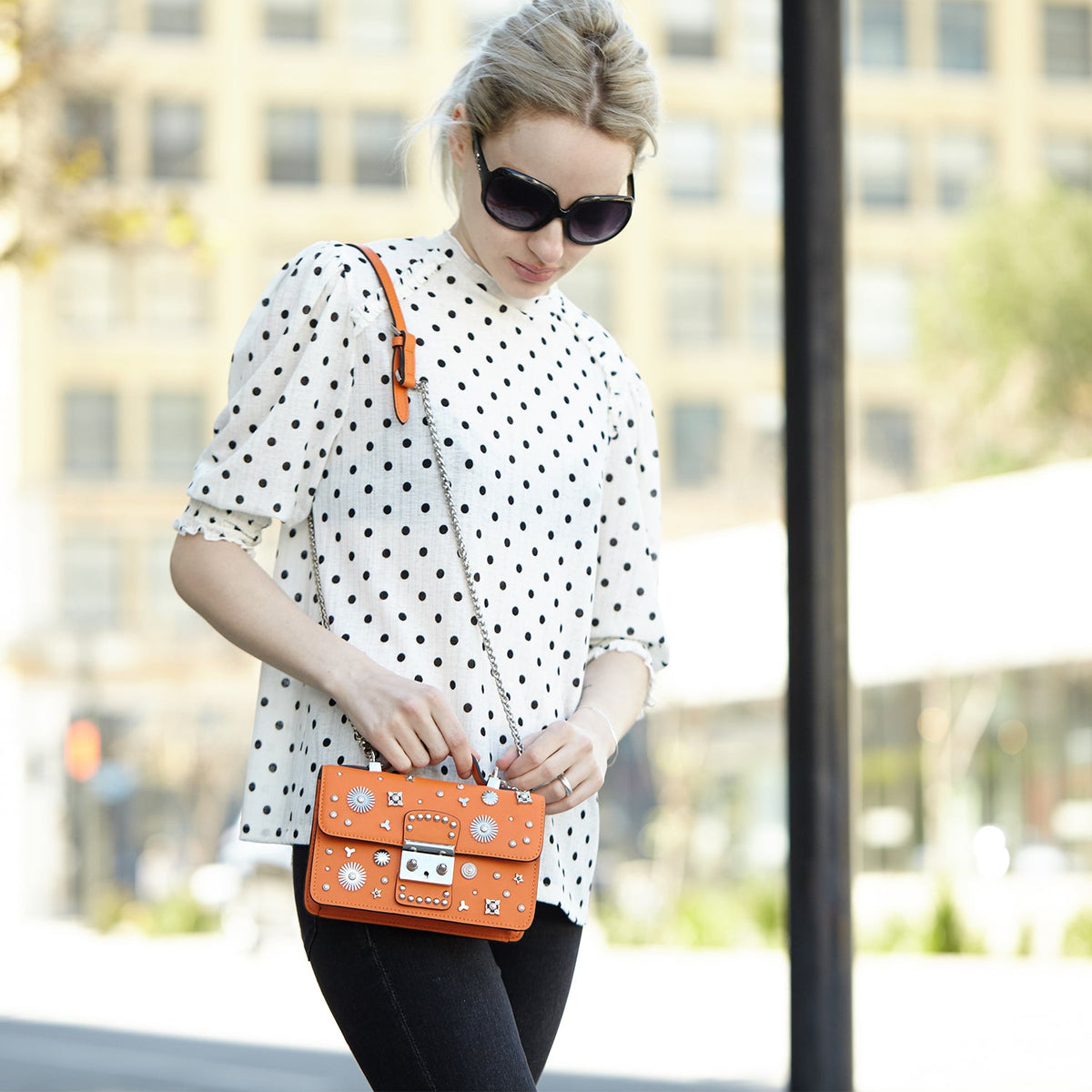 SUSU Hollywood crossbody bag worn with adjustable silver chain strap showing studded details