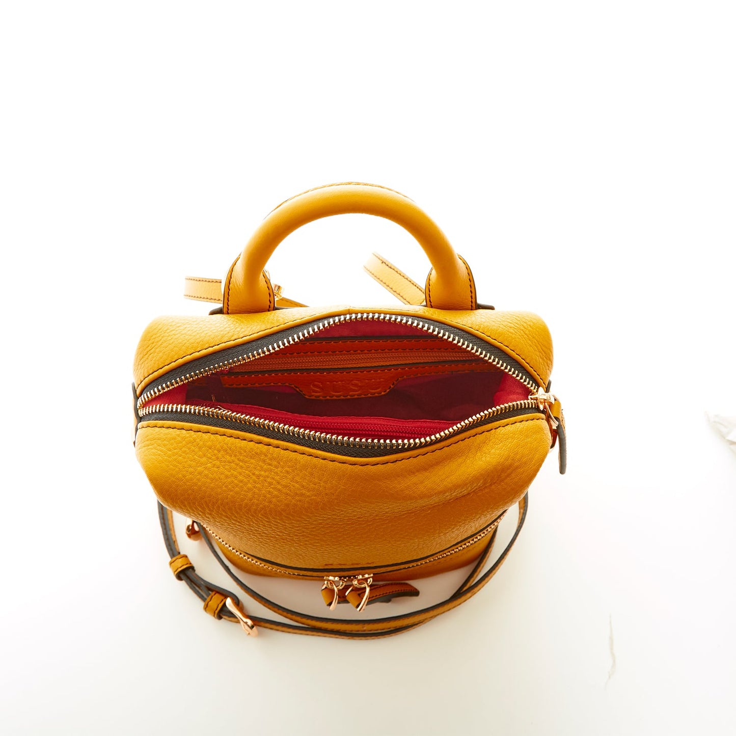 SUSU Ashley yellow leather backpack interior showing red lining and cell phone slot