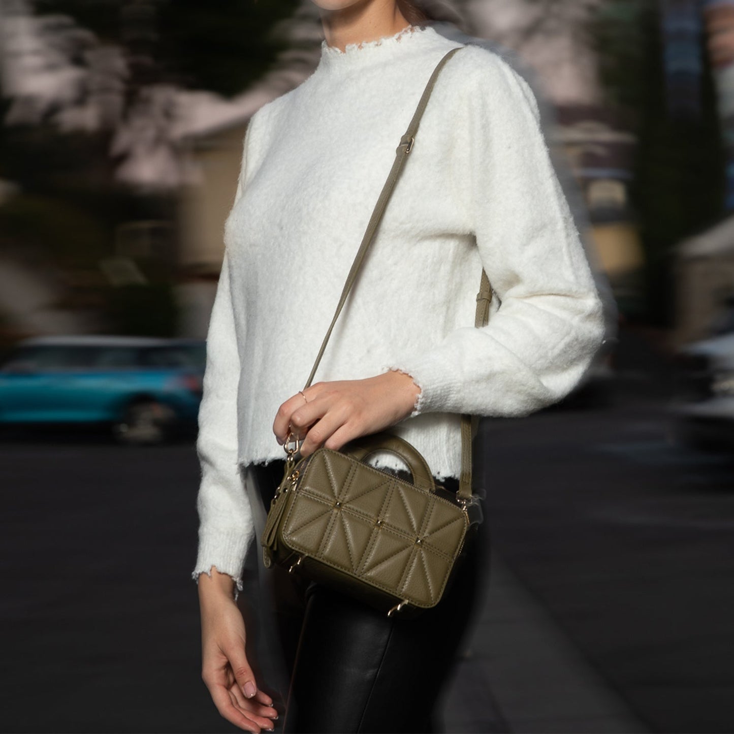 SUSU Taylor crossbody bag worn with adjustable shoulder strap showing quilted texture