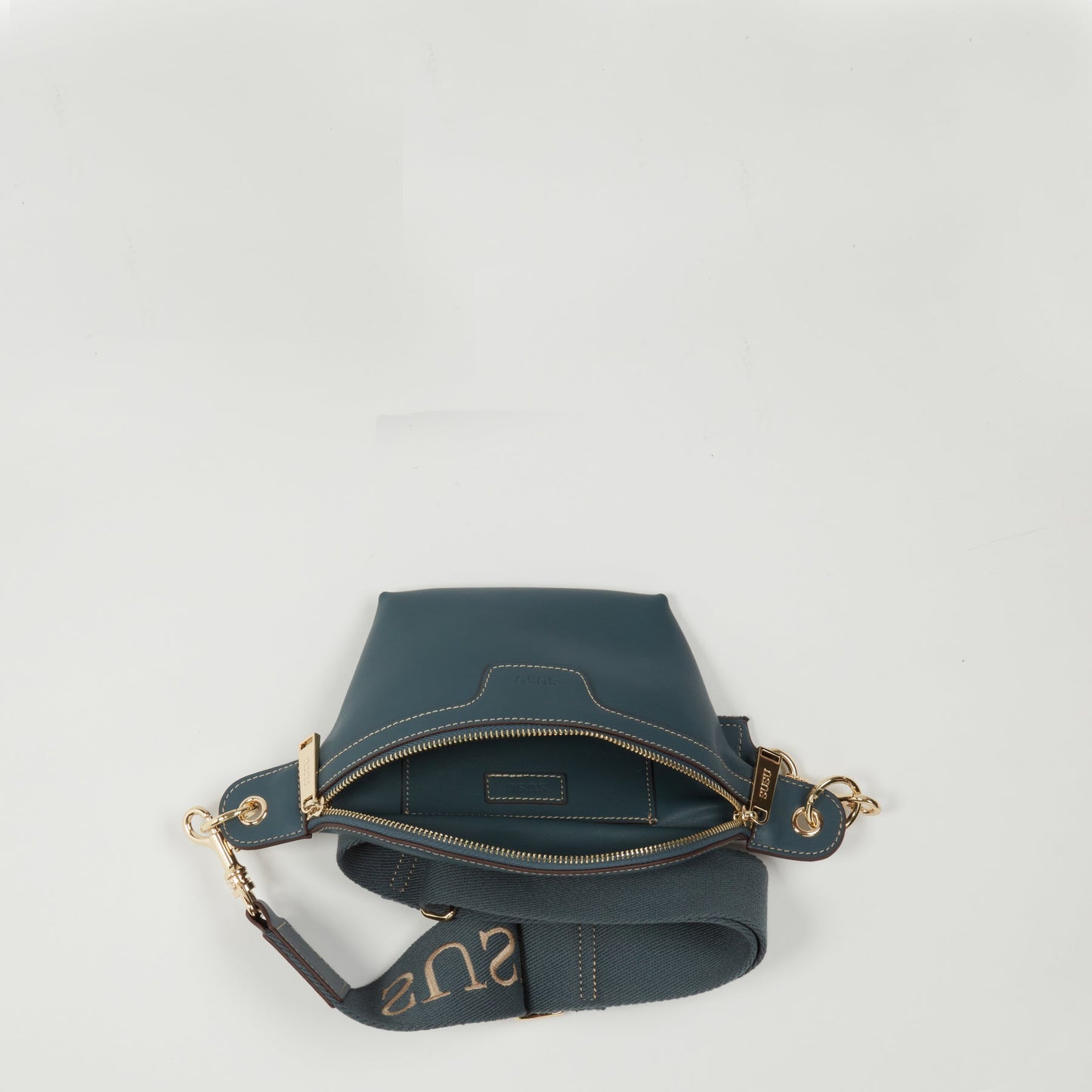 USU leather crossbody sling bag highlighting premium blue leather construction